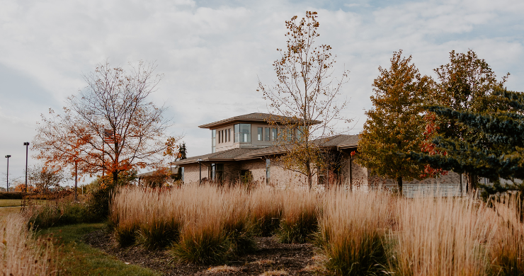 Exterior image of Montgomery Campus in the fall with trees and talls grass.